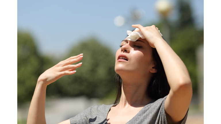 Asian woman drying sweat in a warm summer day