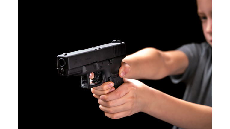 Young White Caucasian Kid Child Boy Holding and Aiming Handgun Shooting