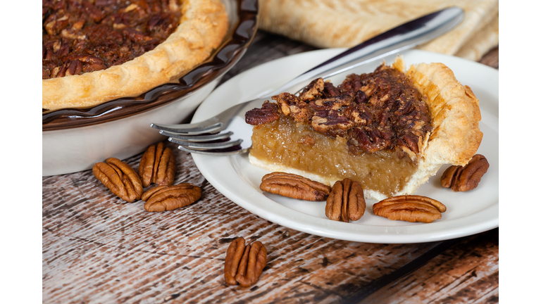 Slice of homemade pecan pie with pecans
