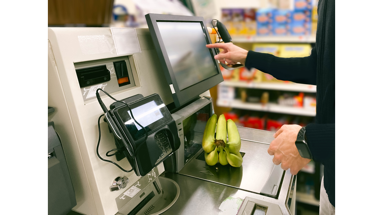 Man Purchases Bananas at Self-Checkout Kiosk