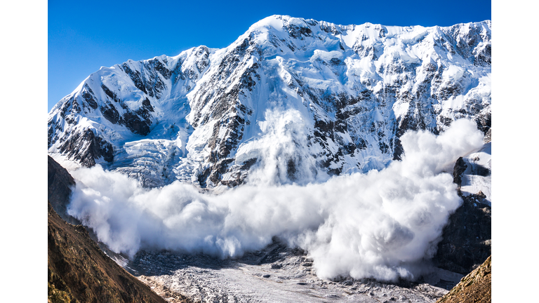 Large avalanche coming down the rocky Caucasus mountain