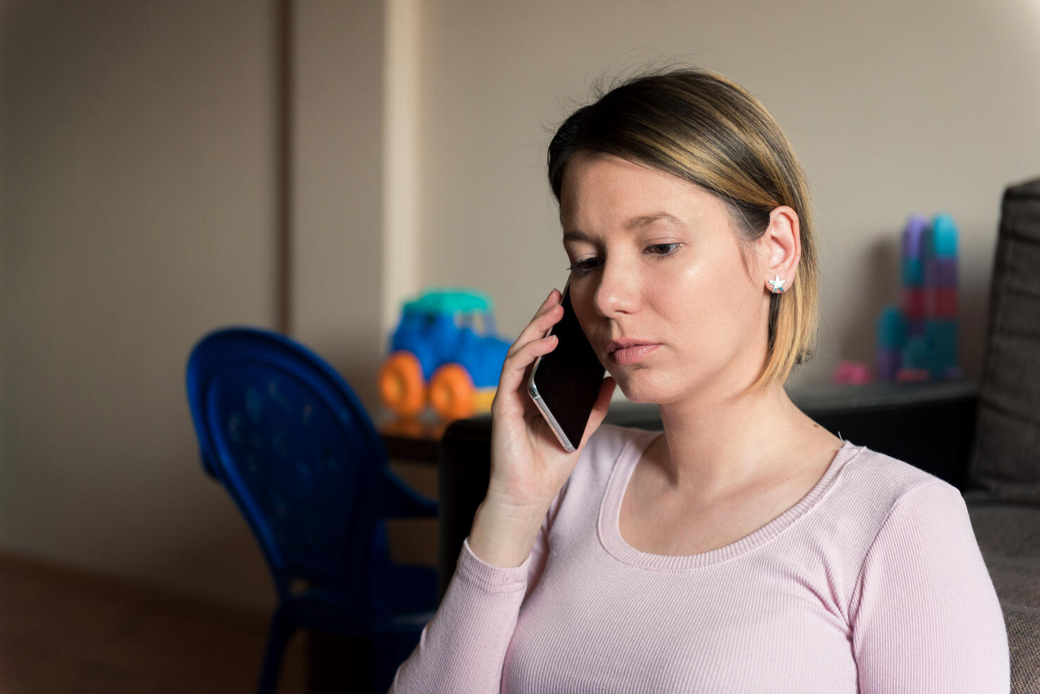 Single mother at home talking on a phone