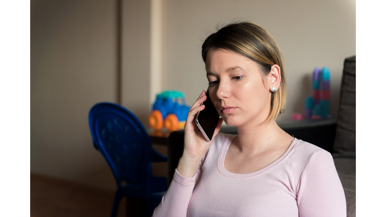 Single mother at home talking on a phone