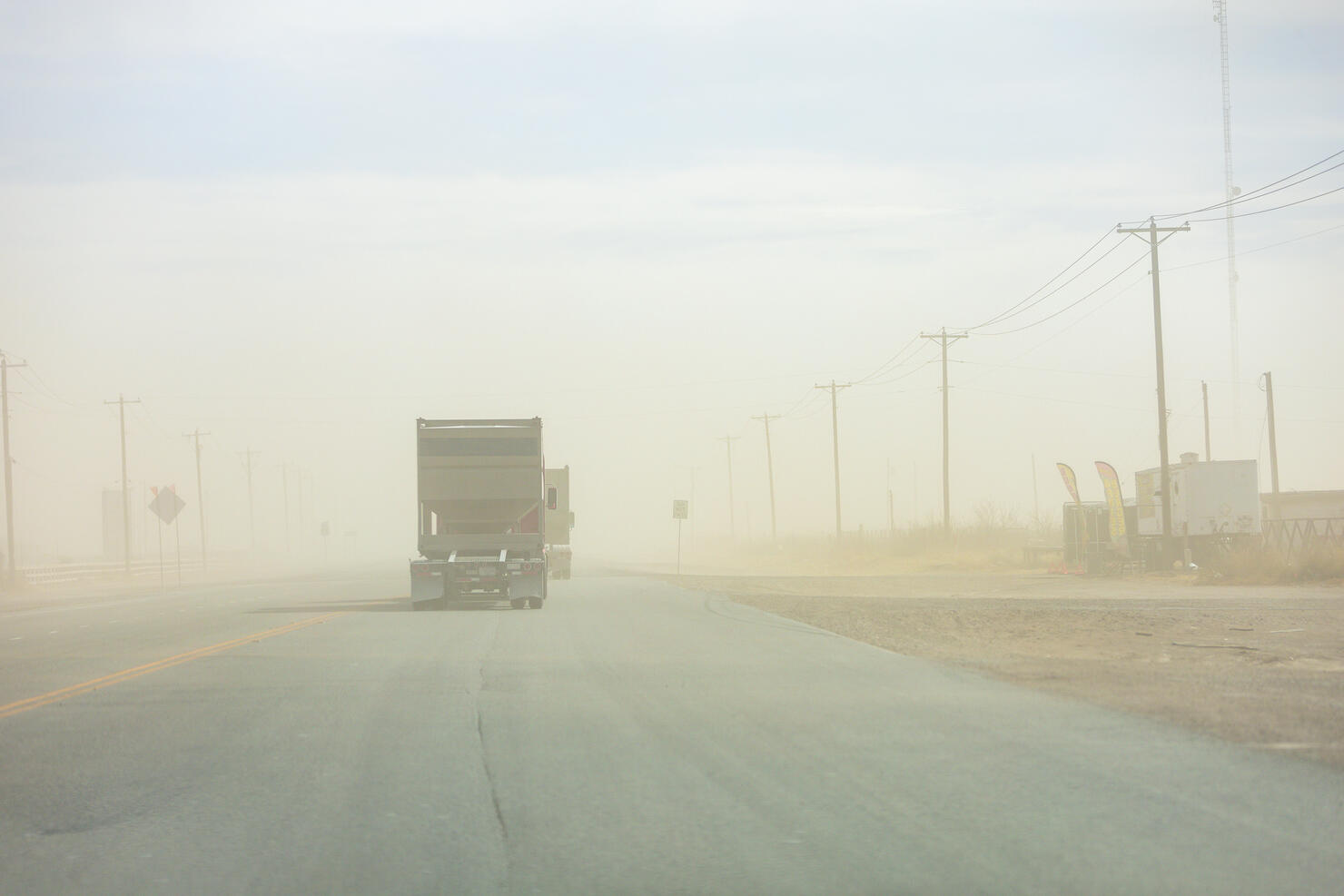 A truck drives through a sand storm near the community of Orla in Reeves County, Texas, USA.