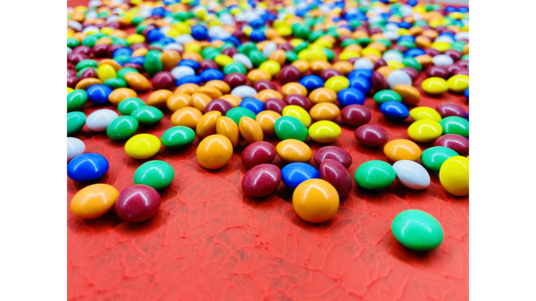 Bright festive background from multicolored sweets.