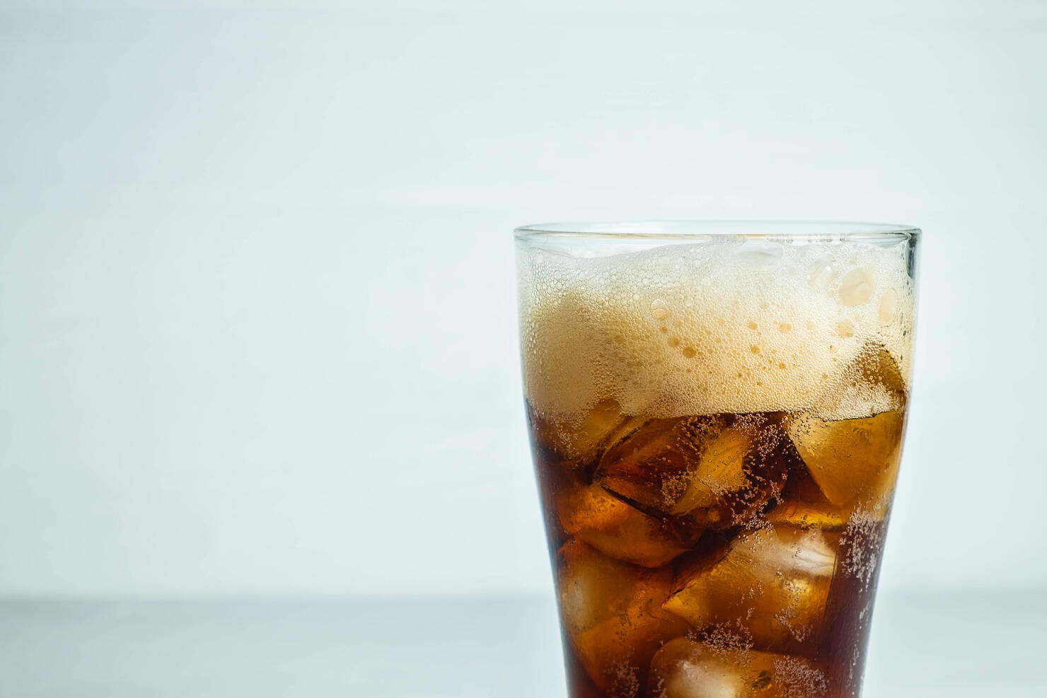 Close-up of drink in glass against white background