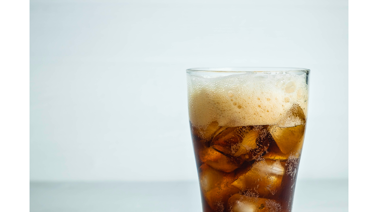 Close-up of drink in glass against white background