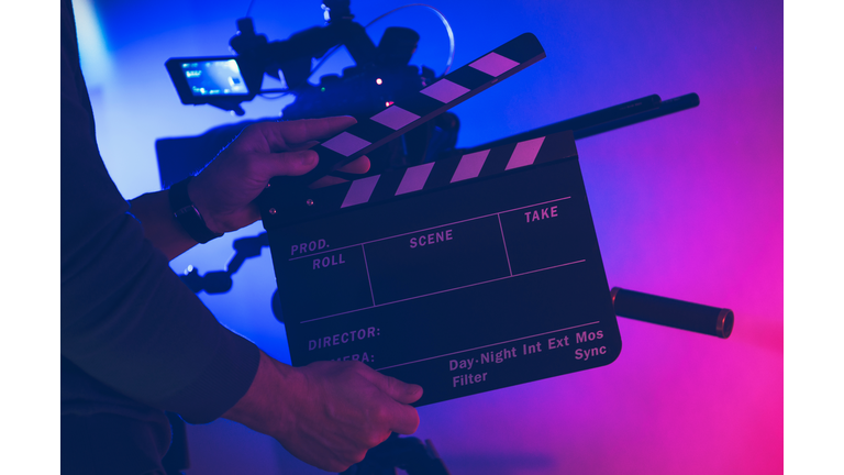 Film Making Professional with Clapperboard in His Hands