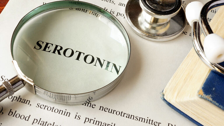 Serotonin written on a page. Human hormones.