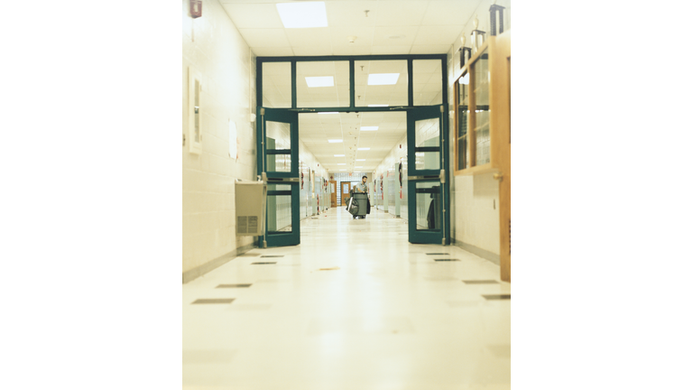 Janitor in School Corridor