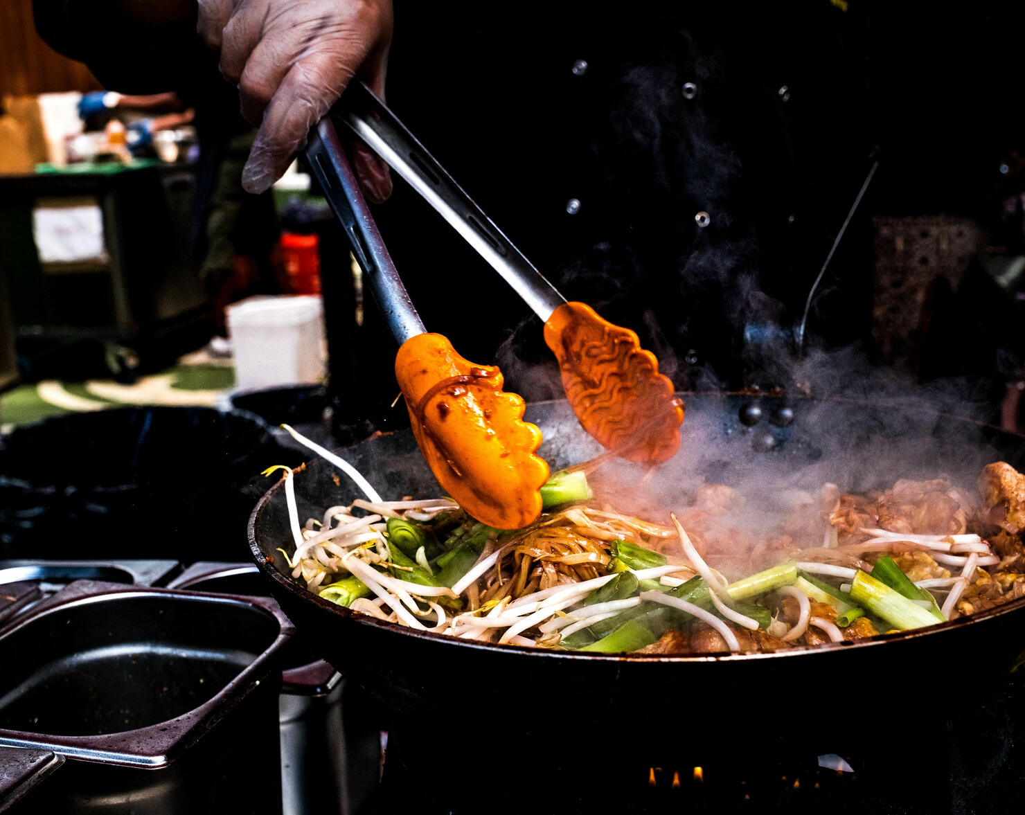 Person Holding Meat On Barbecue Grill