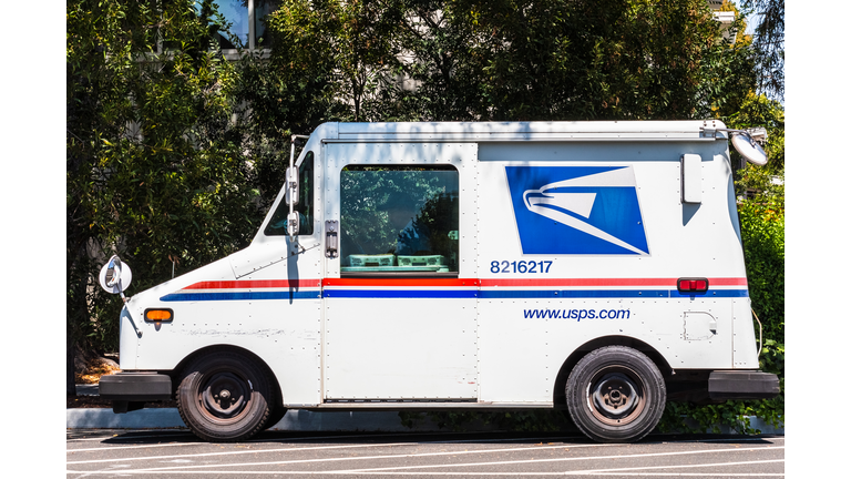 USPS vehicle parked on the side of the road