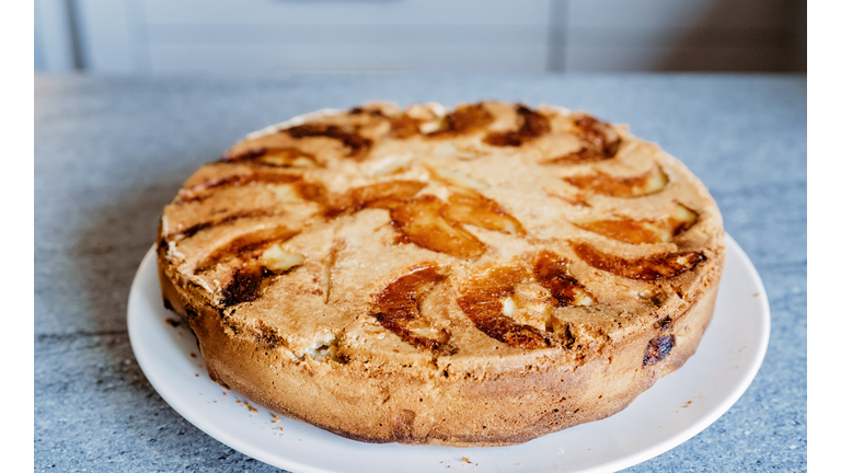 Close up photo of hot homemade apple pie or charlotte. Artisanal food, traditional autumn russian apple cake Sharlotka