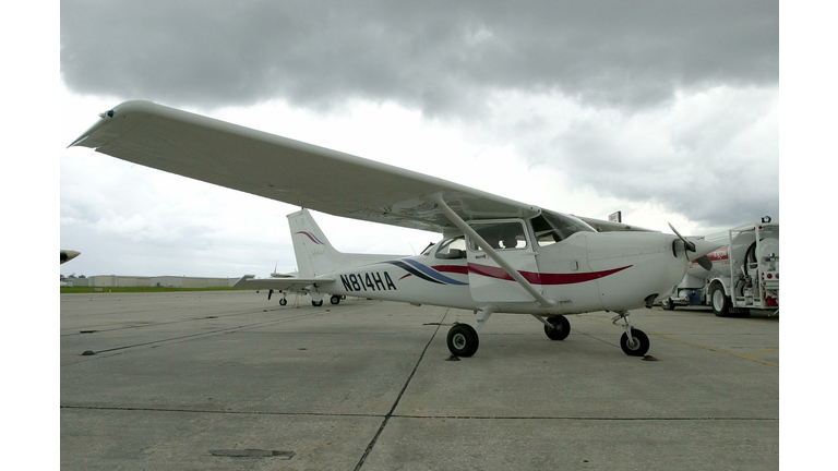 A Cessna Skyhawk single engine plane sits on the r