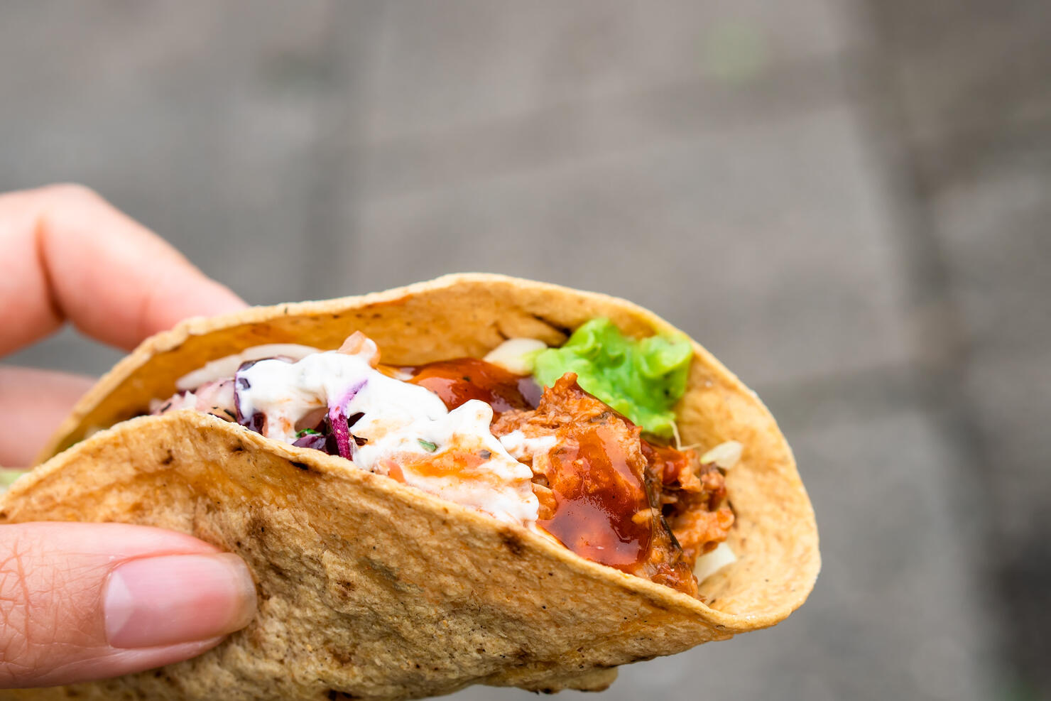 Mexican traditional authentic homemade tacos with pulled pork beef chili con carne serve with tomato salad and avocado guacamole and dip sauce