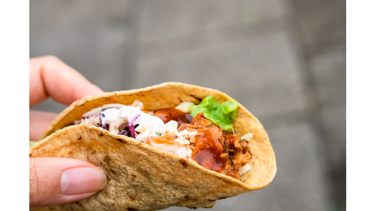 Mexican traditional authentic homemade tacos with pulled pork beef chili con carne serve with tomato salad and avocado guacamole and dip sauce