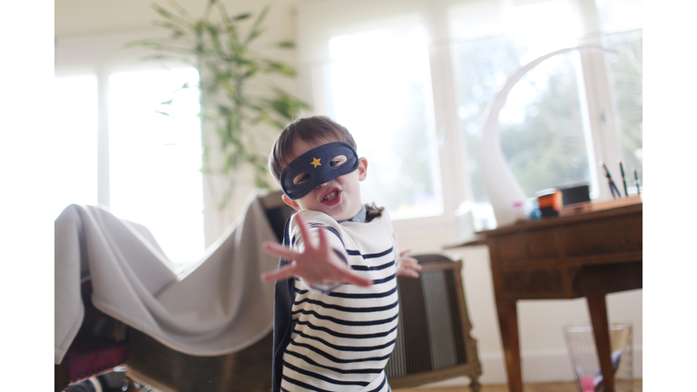 A boy with a mask playing at home