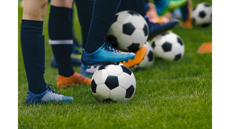 Junior Football Training Session. Players Standing in a Row with Classic Black and White Balls. Youths Practice on Soccer Field. Low Angle Close-up Image of Soccer Boys. Football Education Background