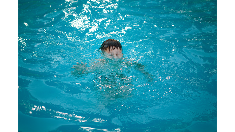 Young boy drowning in the pool