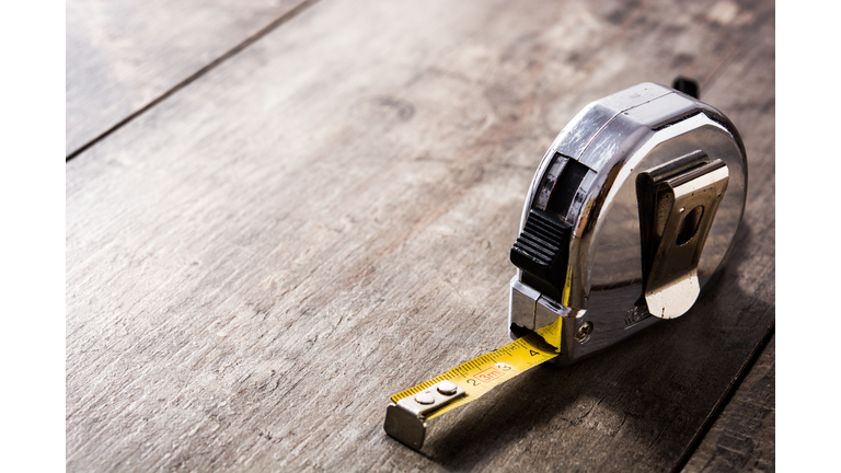 Measuring tape on wooden table
