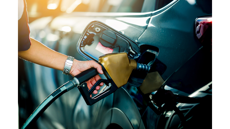 Hand refilling the car with fuel at the refuel station