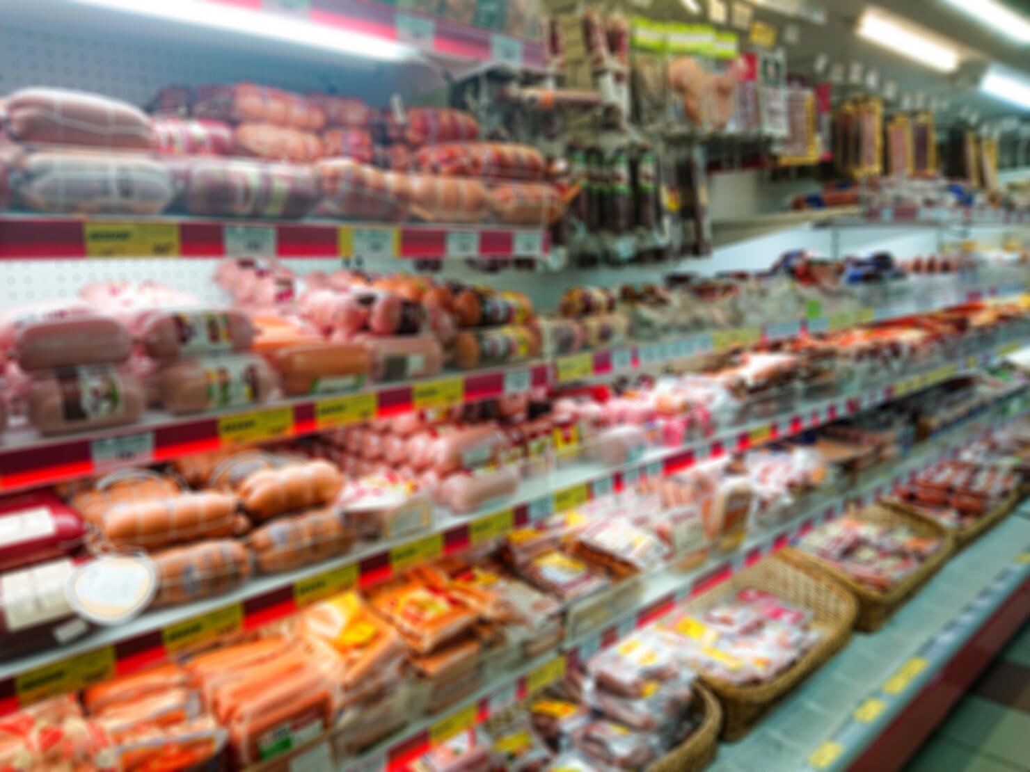 Blurred abstract image. Goods on the shelf of a grocery store. Meat and sausage products