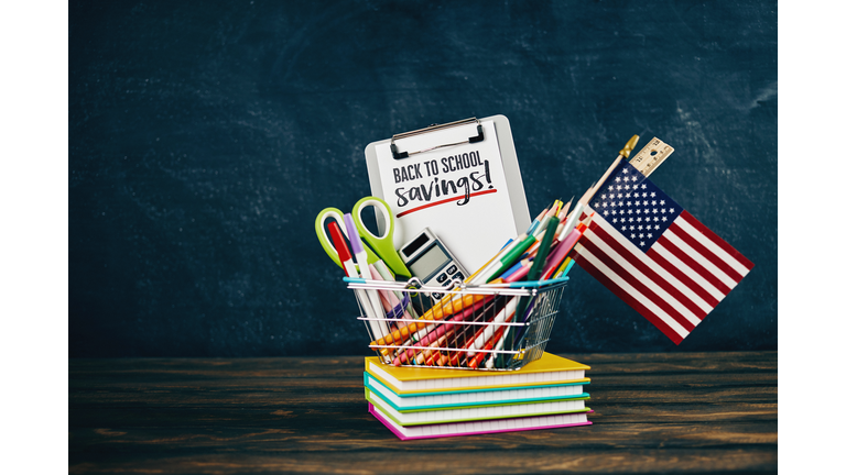 Back to school supplies against weathered chalkboard