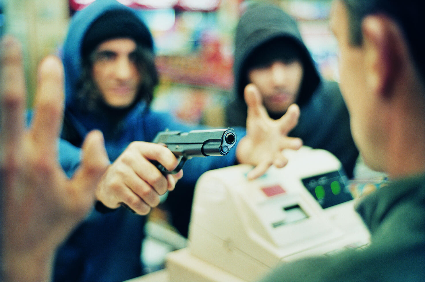 Hooded Criminals Threatening a Shop Assistant with a Gun