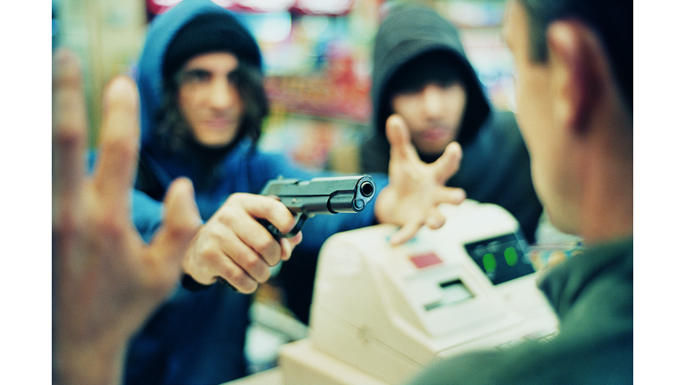 Hooded Criminals Threatening a Shop Assistant with a Gun