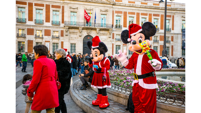Mickey Mouses in Santa's costumes on Puerto del Sol, Madrid