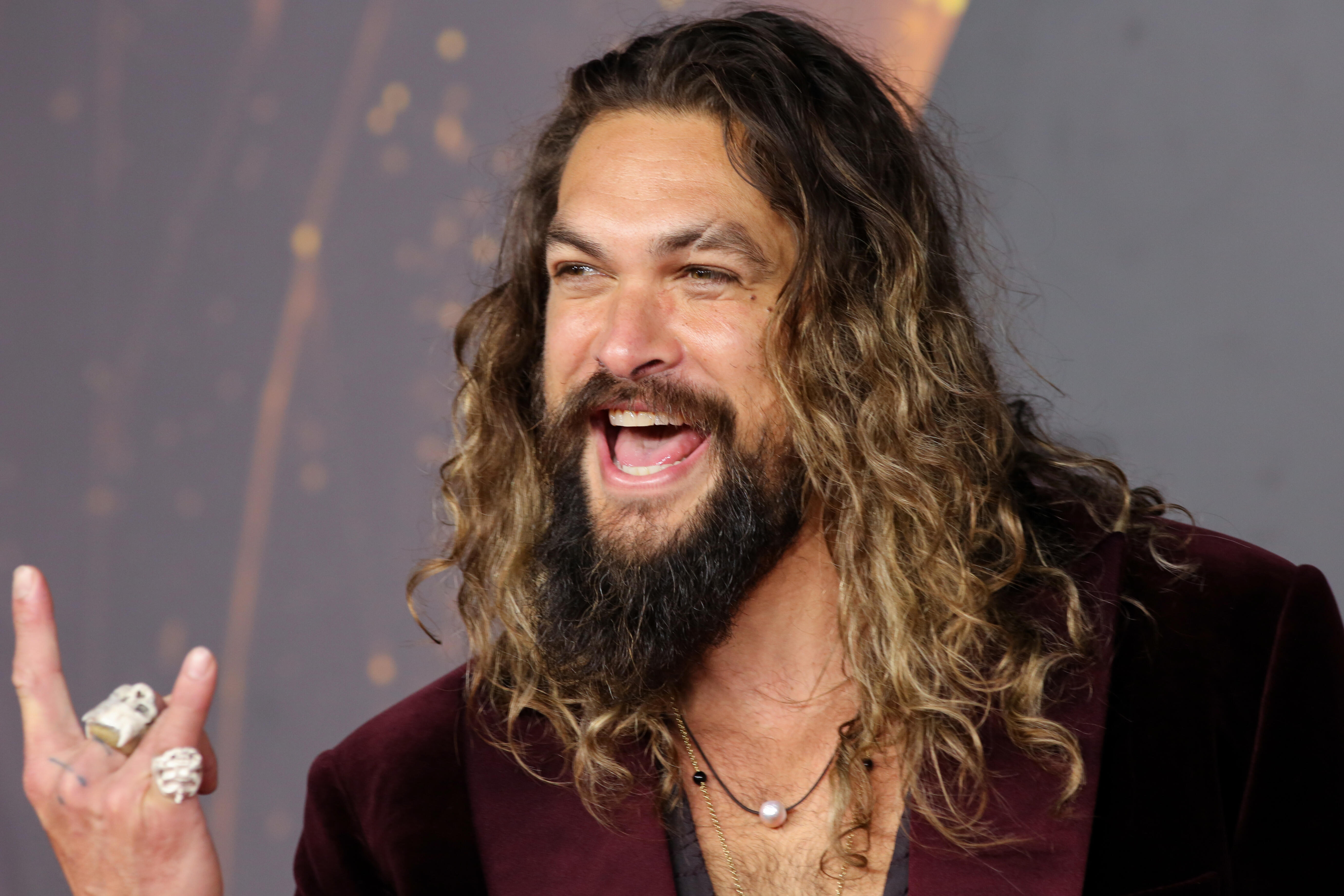 WATCH: Jason Momoa Surprise Passengers As A Flight Attendant | iHeart