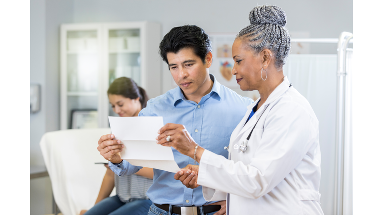 Doctor reviews test results with concerned father