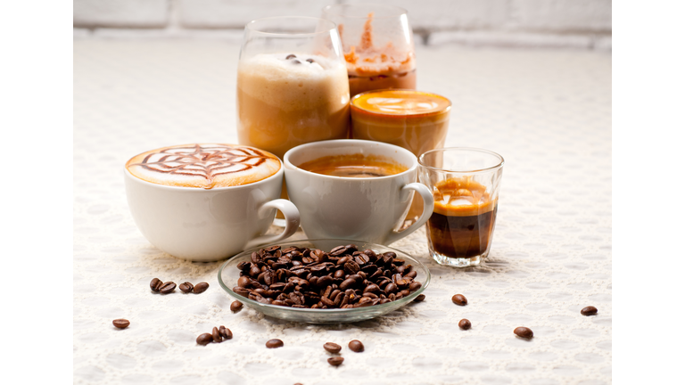 Close-Up Of Coffees With Roasted Coffee Beans Served On Table