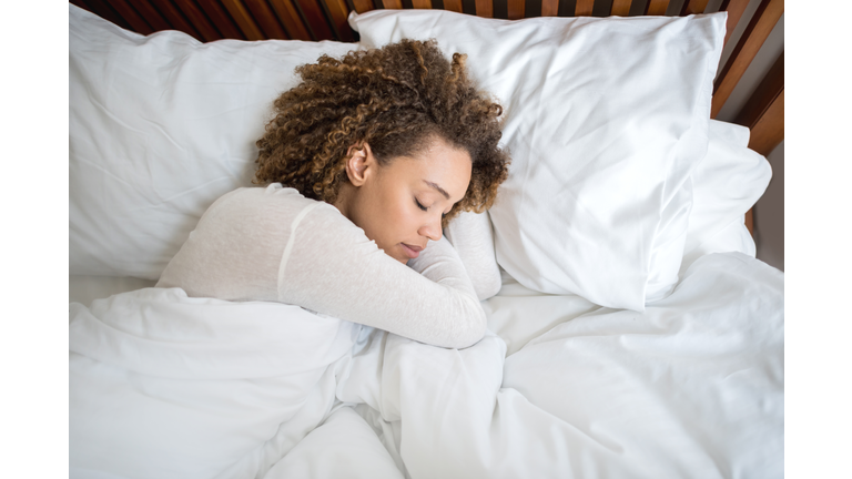 African American woman sleeping in bed