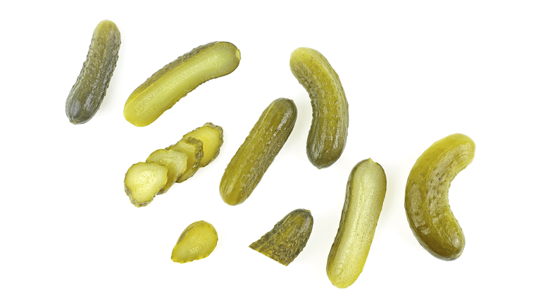 Set of delicious marinated pickled cucumbers isolated on a white background, top view.