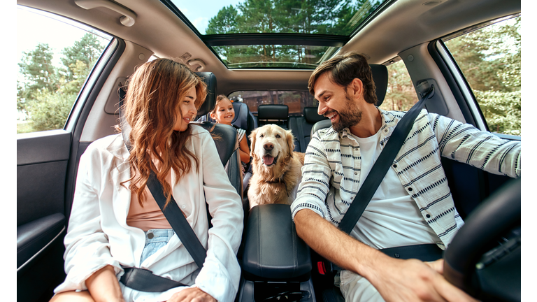 Family with dog in the car