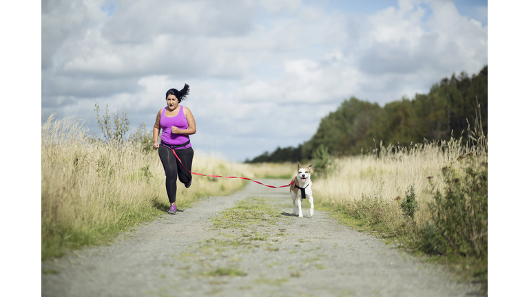 Woman running with dog