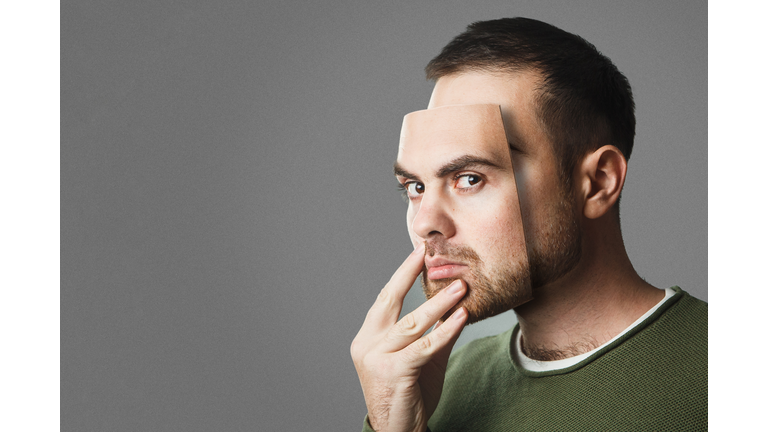 Be Yourself. Handsome man holds a mask of his face