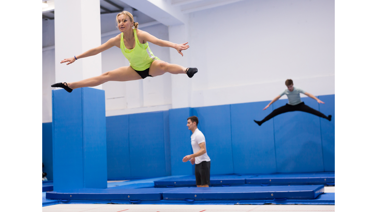 Woman jumping in trampoline center