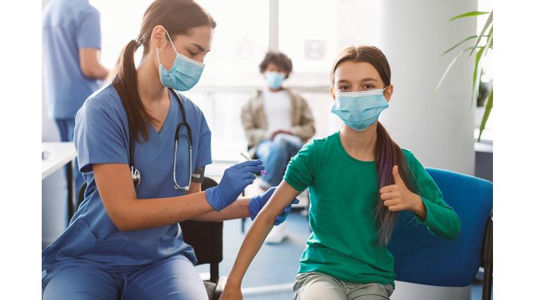 Girl Getting Vaccinated Against Covid-19, Showing Thumbs Up