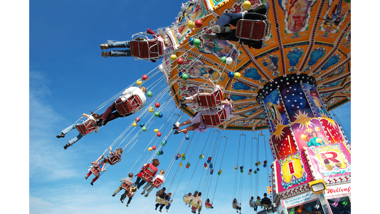 Families at the fair on a swing ride