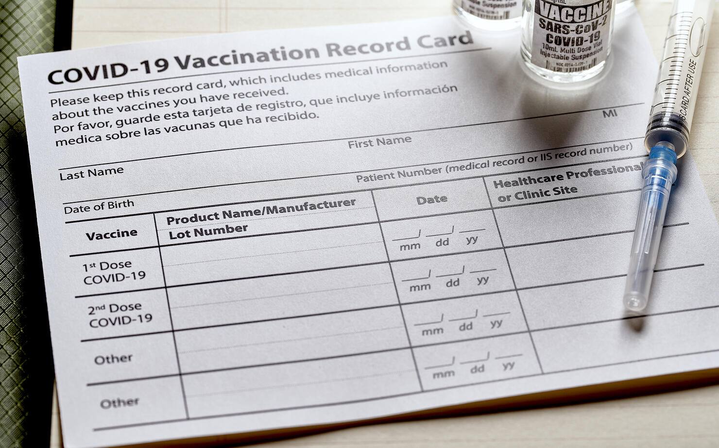 Covid-19 Vaccination card with syringe and vials