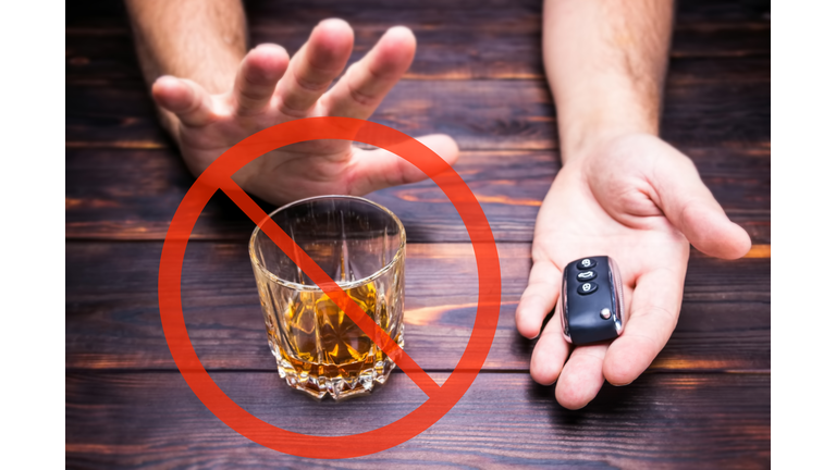 Drunk driving. Glass in man hands. Drink and  auto keys.