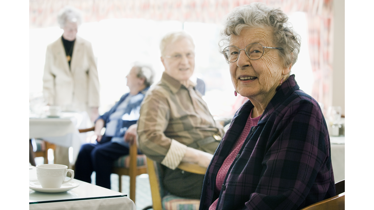 Elderly Woman in Nursing Home Drinking Coffee