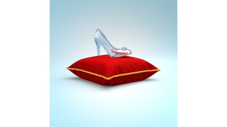 Cinderella glass slipper on the red pillow side view