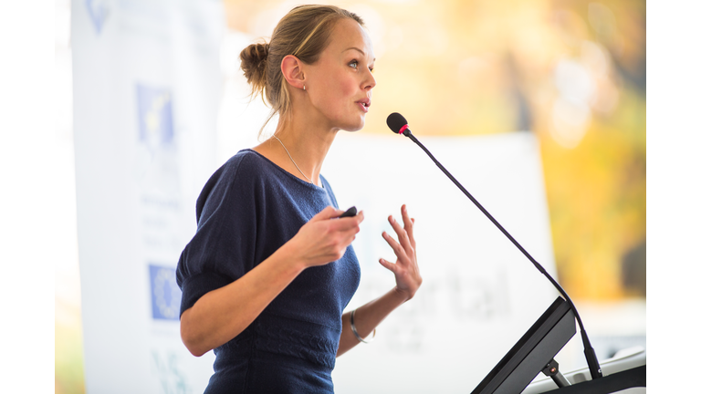 Pretty, young business woman giving a presentation