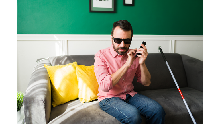 Latin disabled man sending a text