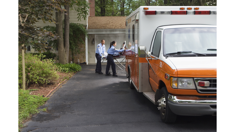 Paramedics putting person into ambulance