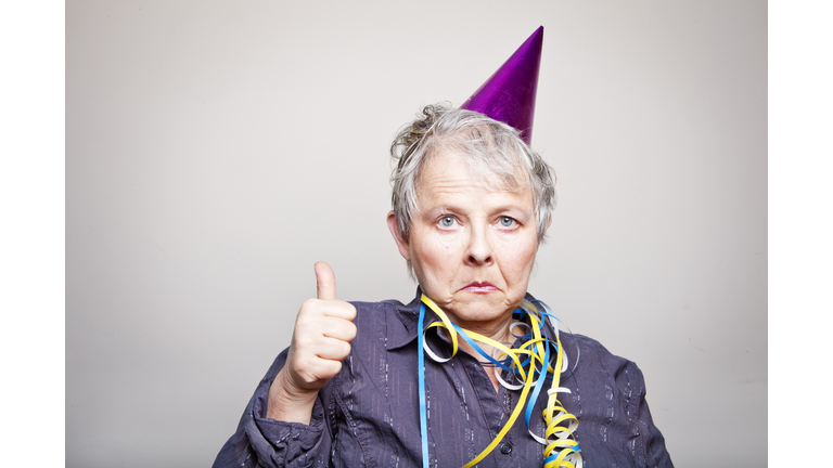 depressed senior woman doing thumbs up