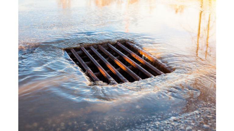 City sewer after the rain. storm sewer on the road It's spring